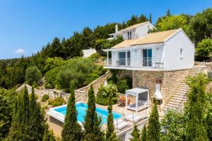 an image of a villa with a swimming pool at Villa Bougainvillea in Vlachopoulátika