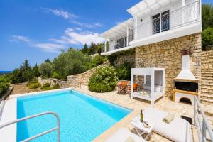 a villa with a swimming pool and a house at Villa Bougainvillea in Vlachopoulátika