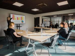 a group of people sitting at a table in a room at Greet Hotel Brest Aéroport in Guipavas