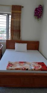 a bedroom with a bed with a wooden frame at Thùy Dung 62 in Ha Long