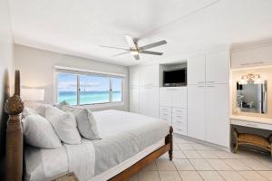 a bedroom with a bed with a ceiling fan at Emerald Hideaway by 30A Escapes in Carillon Beach