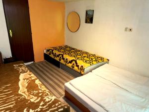 a bedroom with two beds and a mirror on the wall at Chata Lesní Vyhlídka in Splzov