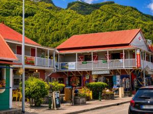 a group of buildings with red roofs on a street at Lacaze Salazie in Hell-Bourg