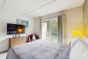 a bedroom with a large bed and a window at Seasons 303 in Warren