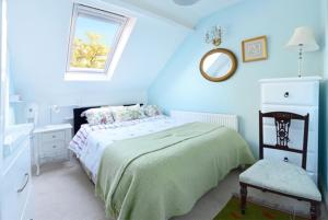 a bedroom with a bed and a mirror and a sink at Charming loft sleeps up to 9 with spa option in Bournemouth