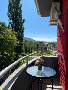 a table on a balcony with a view of a valley at KONAK ViLA MIRKOVIĆ in Soko Banja