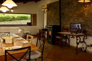 a restaurant with tables and chairs and a window at Borgo Santa Cristina in Castel Giorgio