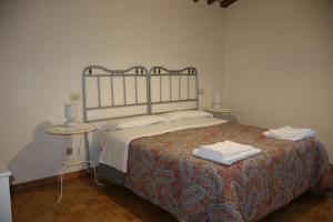 a bedroom with a bed with two towels on it at Borgo Santa Cristina in Castel Giorgio +47 photos