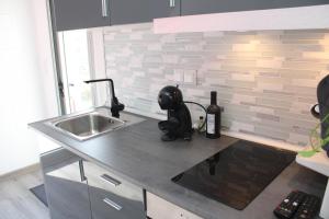 a kitchen with a sink and a counter top at Alojamento ceu azul in Fernao Ferro