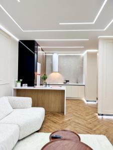 a living room with a couch and a kitchen at DailyRentKZ in Kostanay +6 photos