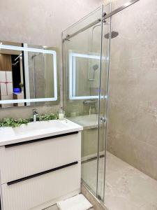 a bathroom with a sink and a shower at DailyRentKZ in Kostanay