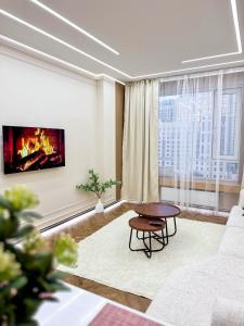 a living room with a couch and a table at DailyRentKZ in Kostanay