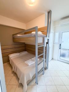 a bedroom with two bunk beds in a room at Tota Marinou in Agioi Apostoli