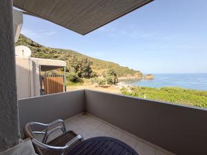 a balcony with two chairs and a view of the ocean at Tota Marinou in Agioi Apostoli
