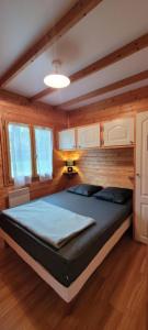 a bedroom with a large bed in a room at Camping de Saint Just - Onlycamp in Arcomie