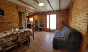 a living room with a table and a dining room at Camping de Saint Just - Onlycamp in Arcomie