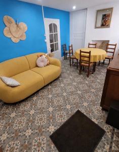 a living room with a couch and a table at Maison de bourg à saint martin le beau in Saint-Martin-le-Beau