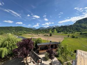 an aerial view of a house with mountains in the background at Guesthouse Ema in Bohinj