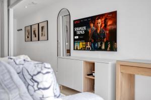 a living room with a flat screen tv on a counter at Work-Friendly 1BR Suite Steps to Eaton Centre in Toronto