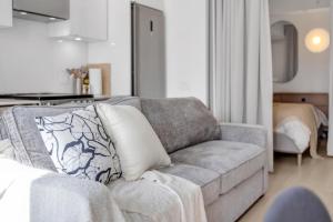 a living room with a couch with a pillow on it at Work-Friendly 1BR Suite Steps to Eaton Centre in Toronto