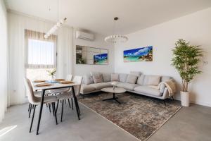 a living room with a couch and a table at Maria Premium BELLA VISTA in Baošići
