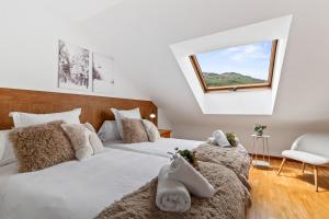 a bedroom with two beds and a window at Trail House in Pola de Lena