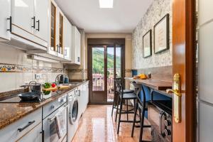 a kitchen with a sink and a counter at Trail House in Pola de Lena