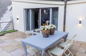 a blue table with flowers on a patio at Grand Danube Hotel in Komárno +34 photos