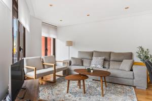 a living room with a couch and a table at Trail House in Pola de Lena
