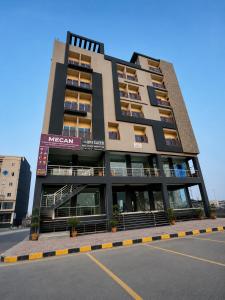 a large apartment building on the side of a street at Motorway Majesty Heights - Near Islamabad International Airport and Motorway in Islamabad