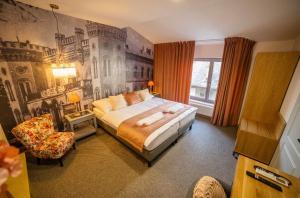 a bedroom with a large bed and a wall mural at Grand Danube Hotel in Komárno