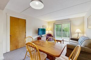 a living room with a table and a couch at Seasons 304 in Warren