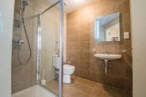 a bathroom with a shower and a toilet and a sink at Casa Lapira in Valletta