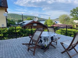 a table and two chairs on a patio with a view at Casa Herban 2 in Moara Ungurului