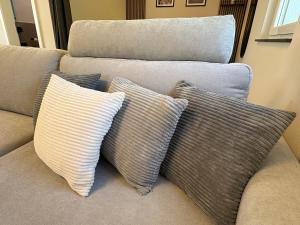 four pillows on a couch in a living room at Ferienhaus Lenz in Kalenborn