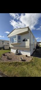 a tiny house sitting on top of a yard at Jemmas Holiday Home in Arbroath