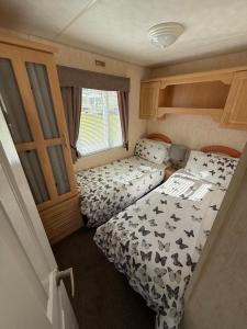 a small room with two beds in a trailer at Jemmas Holiday Home in Arbroath