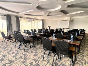a conference room with tables and chairs and a whiteboard at Lake Elementaita Manor in Gilgil +127 photos