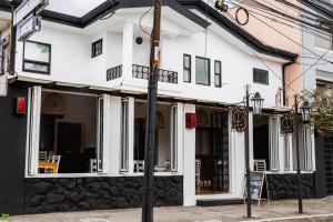 a white building with a sign in front of it at Hotel Luz de Luna Barrio Escalante in San José +27 photos