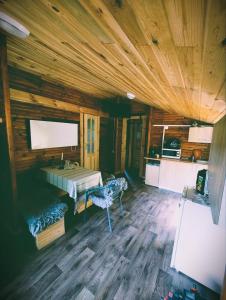 a room with a bed and a tv in a wooden cabin at VerLema House 46 in Augustów