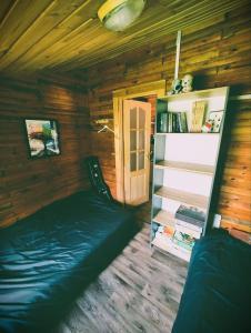 a room with a bed in a wooden cabin at VerLema House 46 in Augustów