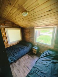 a bedroom with two beds in a log cabin at VerLema House 46 in Augustów