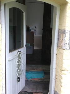 a door leading into a room with a bathroom at mini caravane teardrop in Saint-Denis