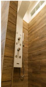 a bathroom with a shower with a wooden floor at Elite in Monte Compatri
