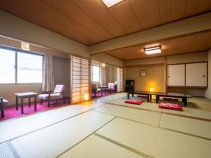 a room with a table and chairs in a room at Mercure Urabandai Resort & Spa in Kitashiobara