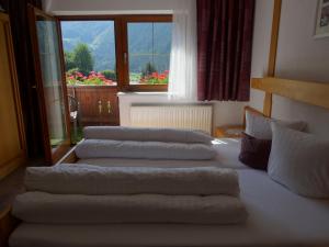 a group of four pillows on a bed in a room at Haus Hackl in Jerzens