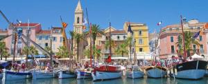 a group of boats docked in a harbor with buildings at maison cosy pour 4 à 5 personnes 10mns des plages in Sanary-sur-Mer