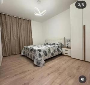 a bedroom with a bed in a room with wooden floors at B&b Antonia in SantʼAntonio Abate +2 photos