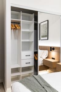 a bedroom with a mirror next to a bed at Widmr Residences in Toronto