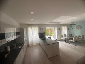 a kitchen and living room with a table and a dining room at Shine Home in Klagenfurt